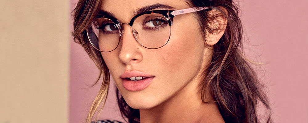 Woman wearing GUESS glasses